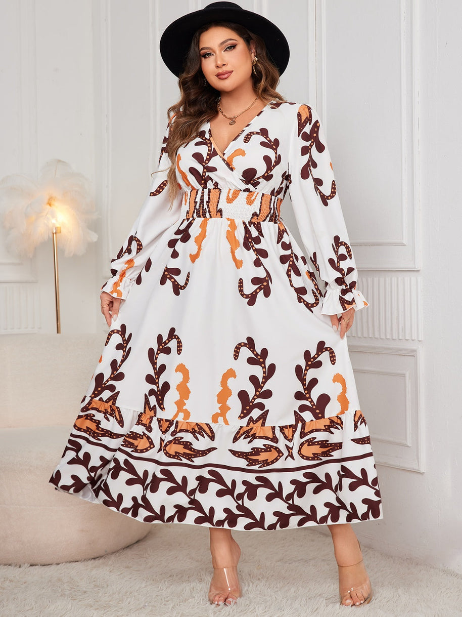 Plus size printed surplice dress with flounce sleeves and ruffled details.