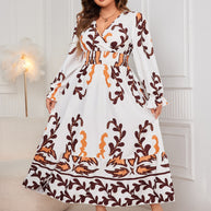 Plus size printed surplice dress with flounce sleeves and ruffled details.