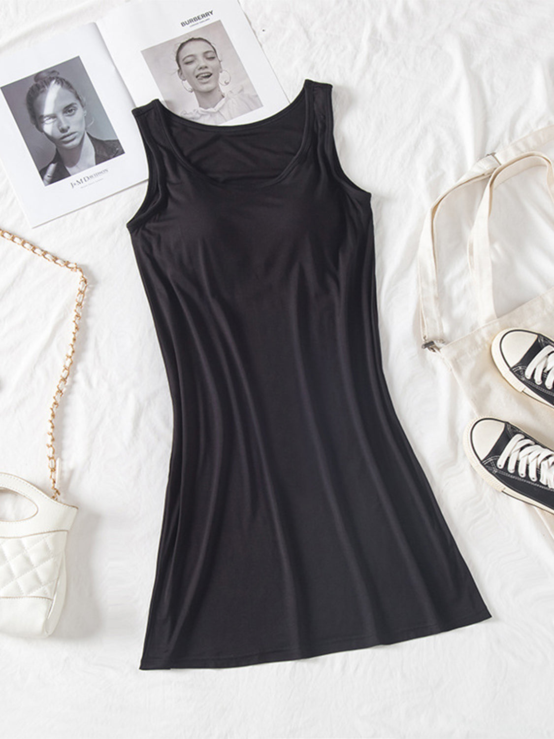 Round neck mini tank dress with wide straps and moderate stretch in black.