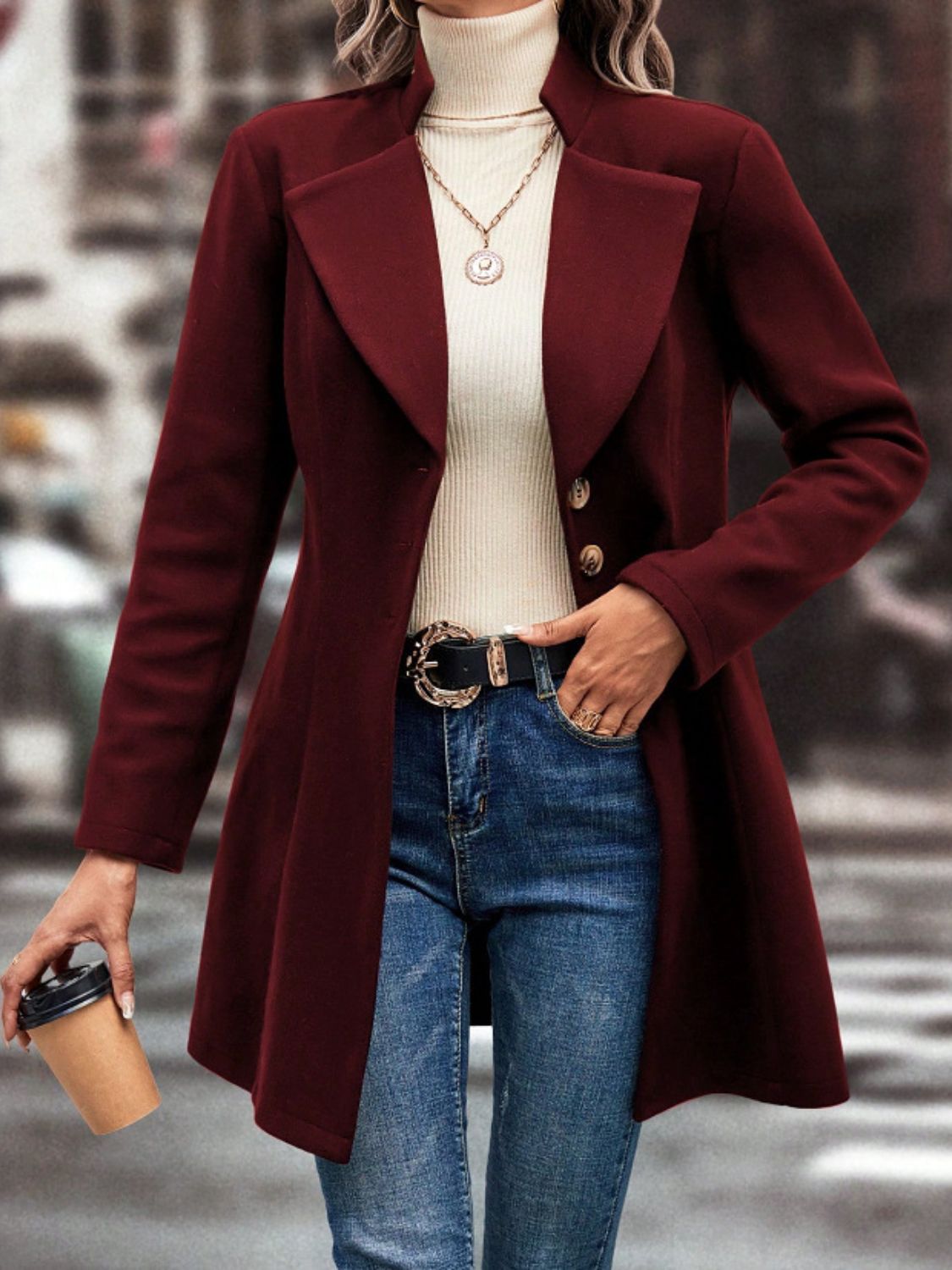 Collared neck button up long sleeve coat in burgundy worn with jeans and turtleneck.