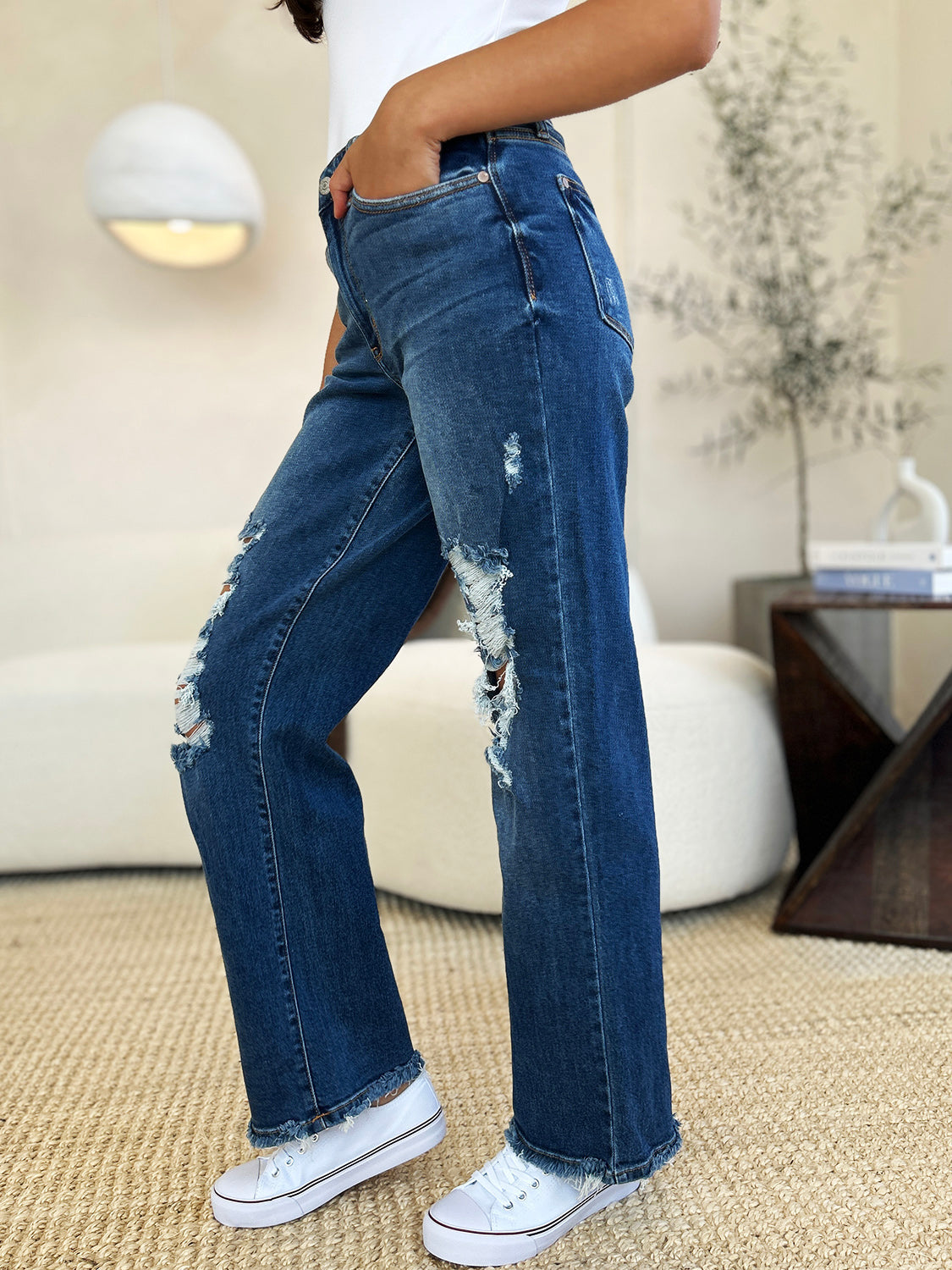 Judy Blue mid-rise distressed raw hem jeans with moderate stretch and a chic casual style.