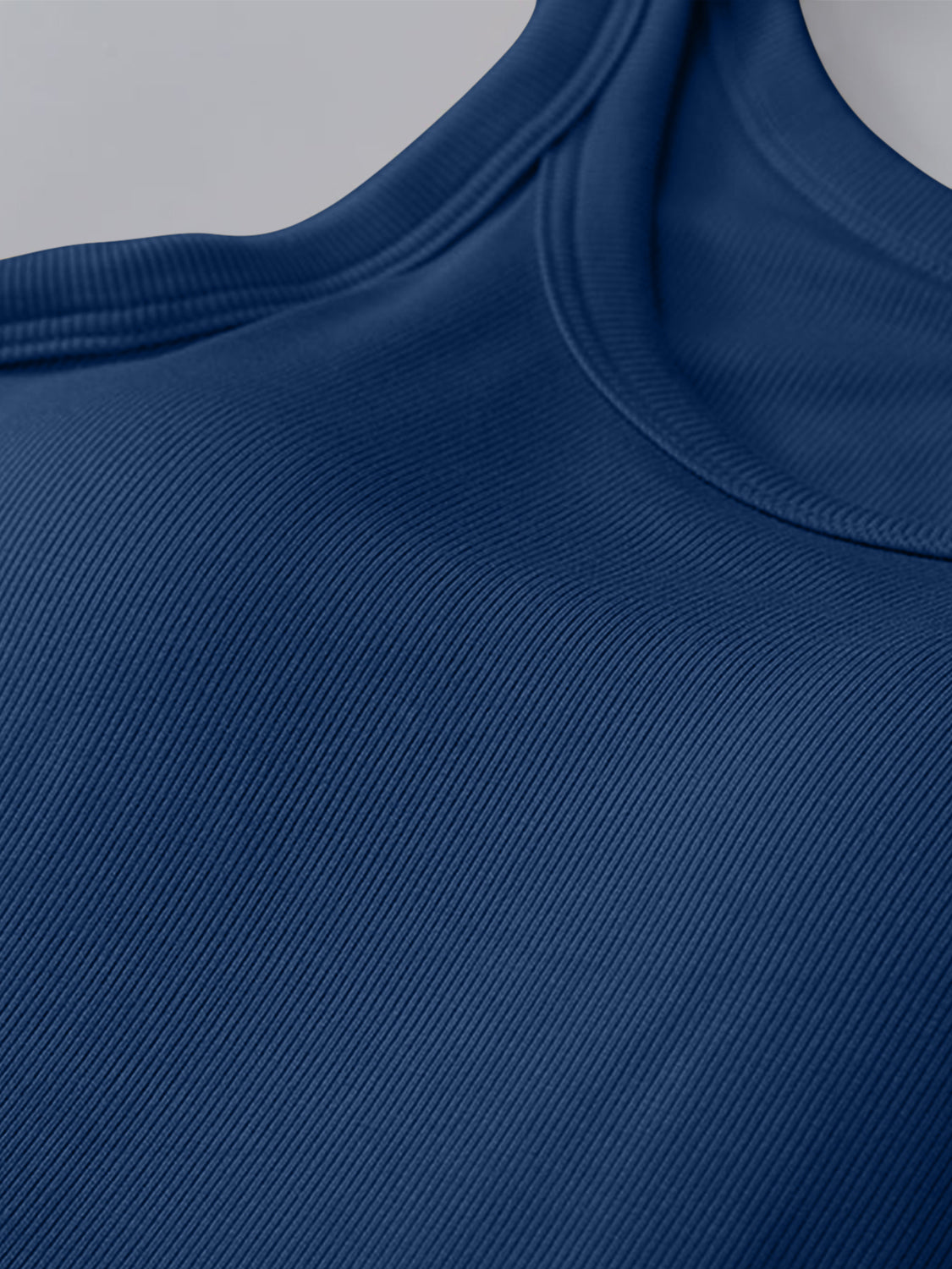 Round neck tank with bra in opaque blue fabric, moderate stretch, machine washable.