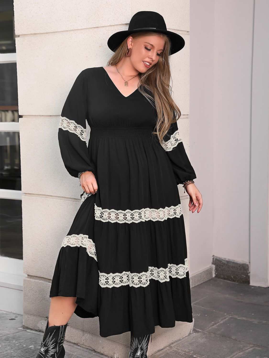 Plus size black midi dress with lace detail, V-neck, and long sleeves.