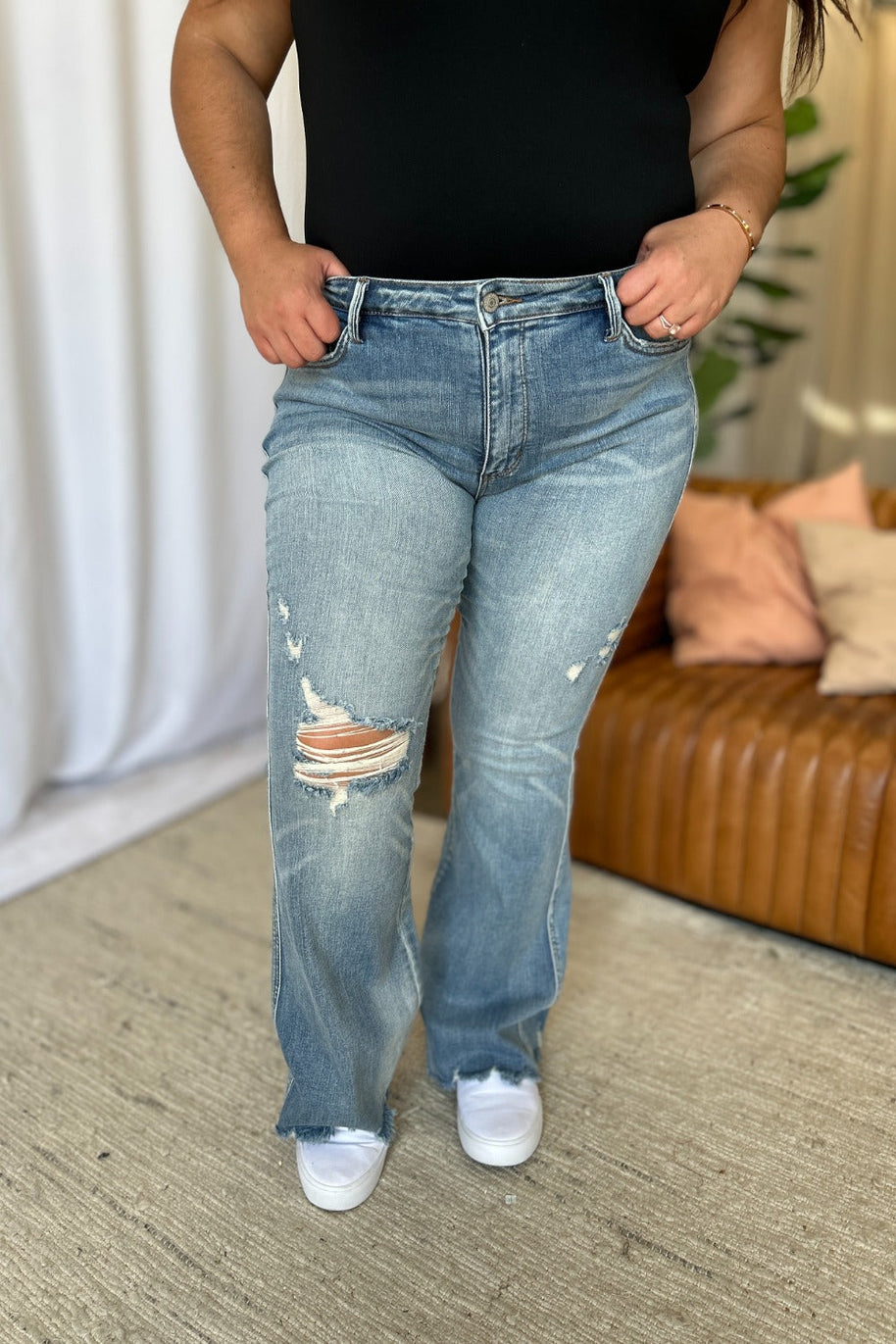 Judy Blue full size medium rise distressed flare jeans with tummy control and raw hem.