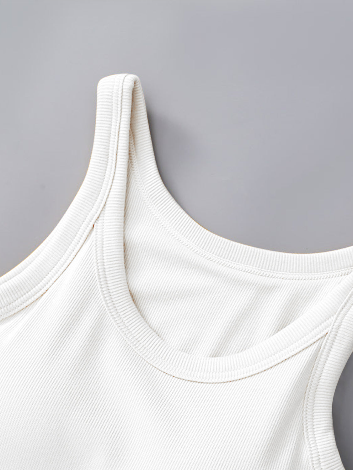 Round neck tank with bra in white fabric, featuring moderate stretch.