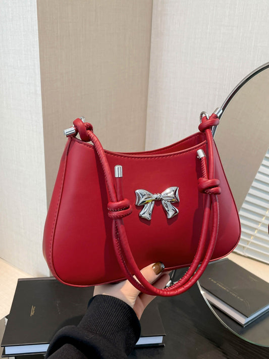 Small red bow PU leather knotted strap handbag with silver accents.