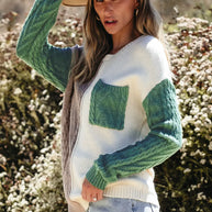 Color block round neck long sleeve sweater with pocket, worn by woman outdoors.