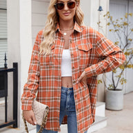 Mandy Plaid Button Up Long Sleeve Shirt in orange, featuring buttons and pockets, worn by a model with jeans.