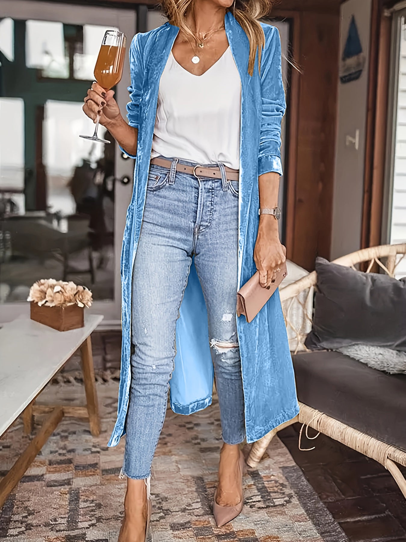 Open front long sleeve coat in light blue, slit feature, worn over casual outfit.